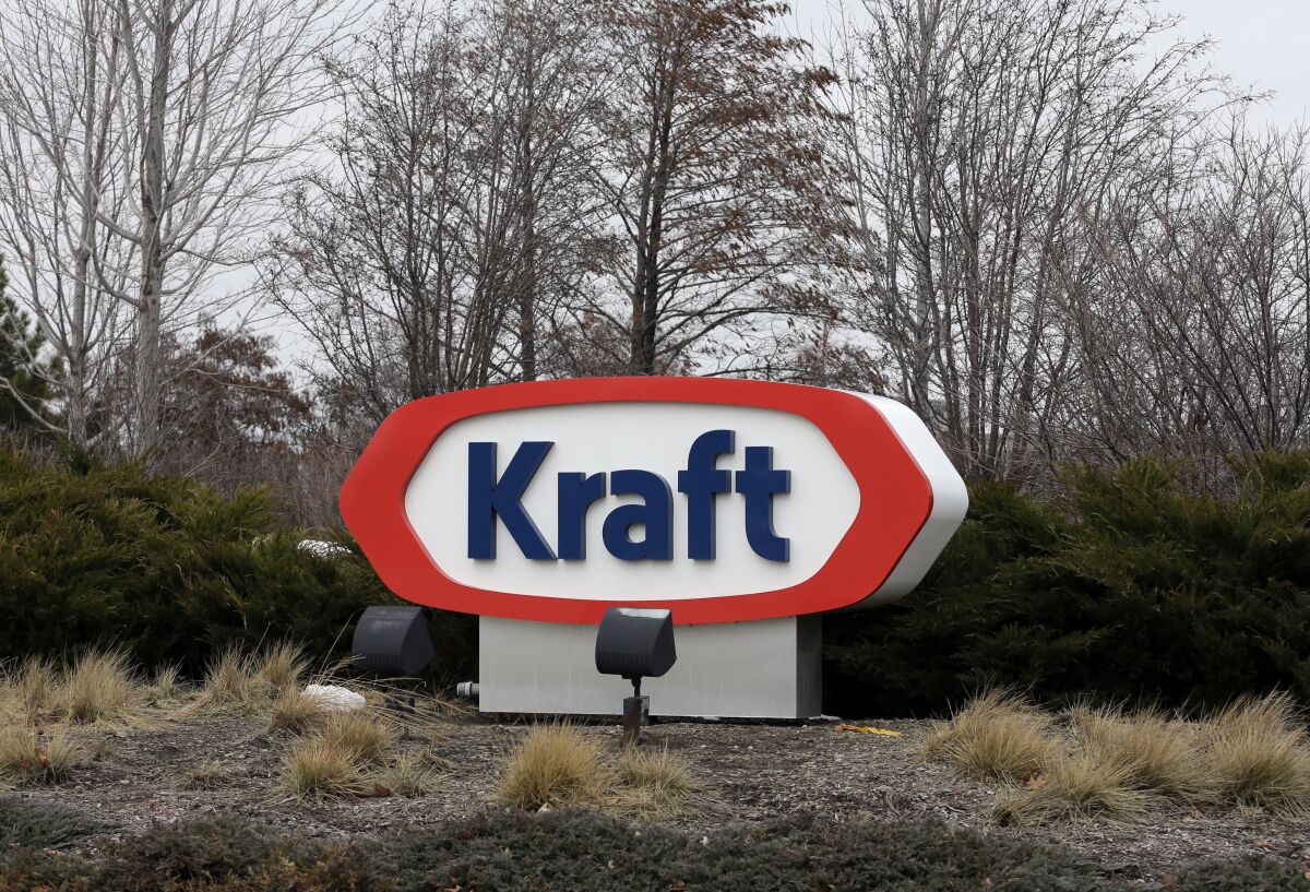 FILE - This Wednesday, March 25, 2015, file photo shows the Kraft logo outside of the company's headquarters in Northfield, Ill. Kraft Heinz Co. is agreeing to pay $62 million to settle charges of improper accounting of what it once claimed were cost savings. Two former senior executives have agreed to pay civil penalties. The Securities and Exchange Commission said Friday, Sept. 3, 2021, that from late 2015 through 2018, Kraft boasted about cost savings that were actually unearned discounts and gave false reports about contracts with suppliers. (AP Photo/Nam Y. Huh, File)