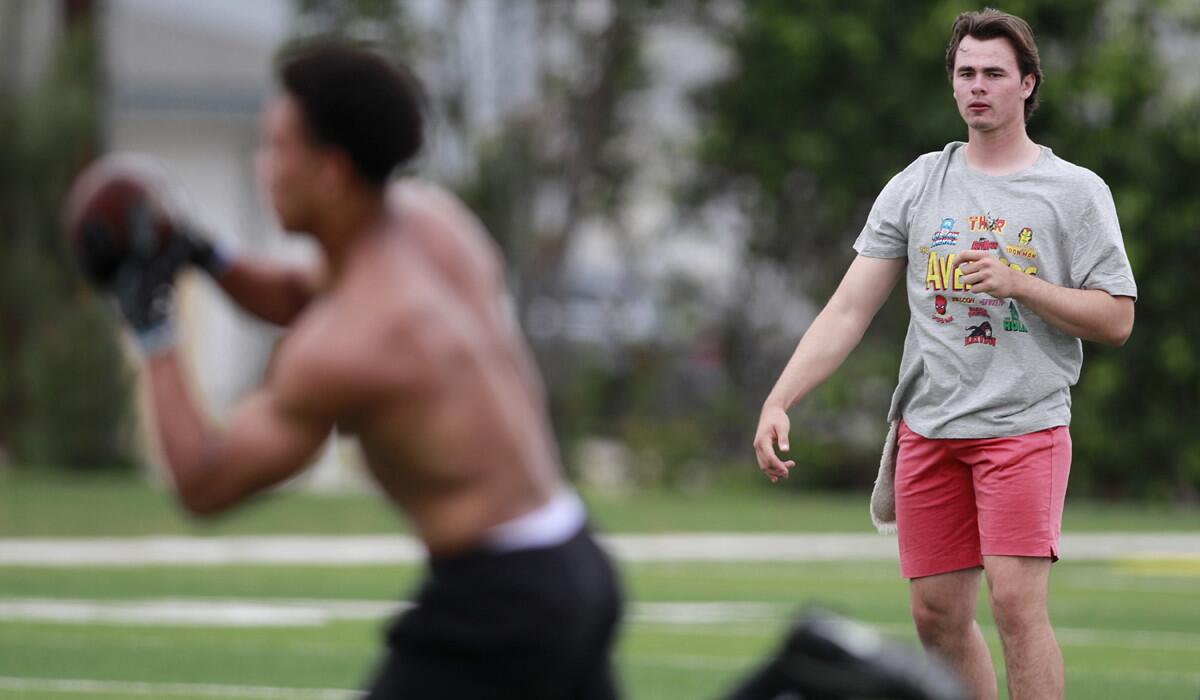 Incoming USC freshman quarterback J.T. Daniels passes to his teammate, wide receiver Amon-Ra St. Brown at Golden West College in Huntington Beach on May 30.