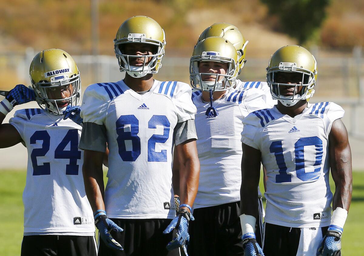 Receivers Eldridge Massington (82) and Kenneth Walker III (10) are competing for starting spots during UCLA's training camp.