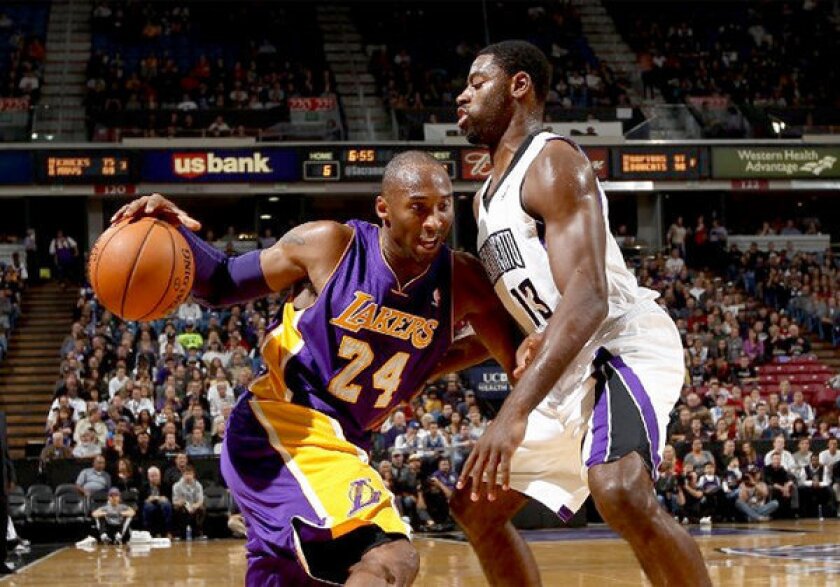 Kings guard Tyreke Evans, right, guards Kobe Bryant earlier this season. Bryant is doubtful for the game Sunday.