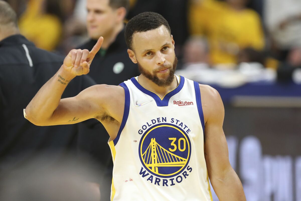 Golden State Warriors guard Stephen Curry (30) celebrates during the second half of Game 5 of basketball's NBA Finals against the Boston Celtics in San Francisco, Monday, June 13, 2022. (AP Photo/Jed Jacobsohn)