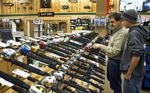 Customers check out more than 260 reels on display at the 185,000-square-foot Cabela's in Rogers, Minn.