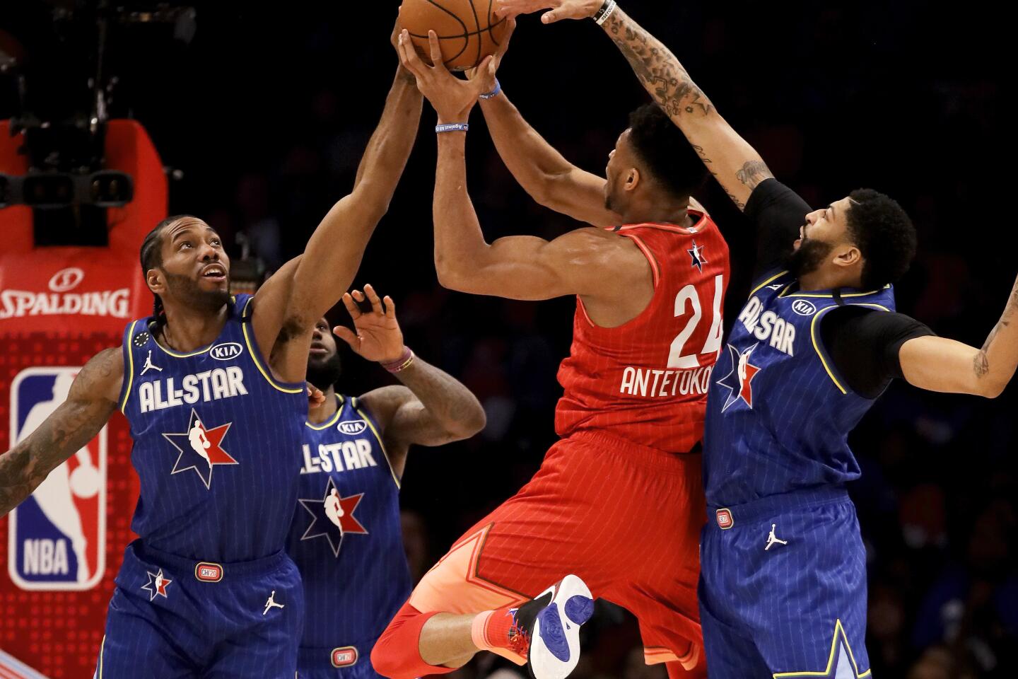 Bucks star Giannis Antetokounmpo tries to take a shot while covered by Clippers forward Kawhi Leonard, left, and Lakers forward Anthony Davis during the 69th NBA All-Star game on Feb. 16, 2020, at United Center in Chicago.