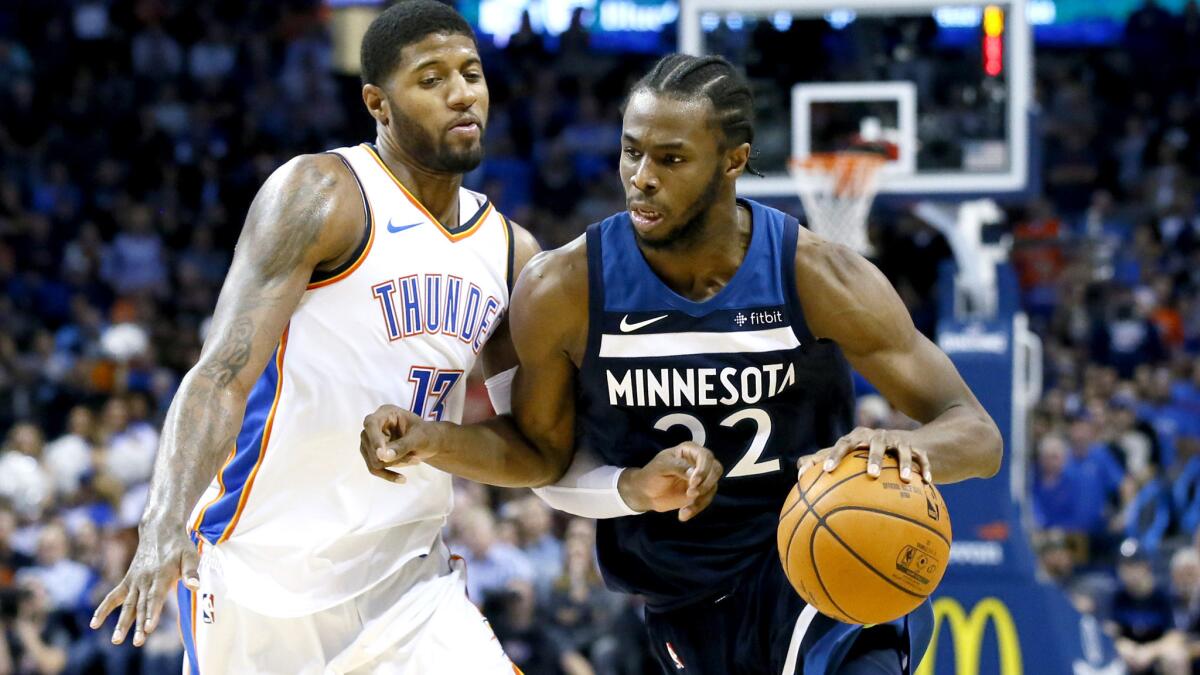 Timberwolves forward Andrew Wiggins tries to drive past Thunder forward Paul George during the fourth quarter Friday.