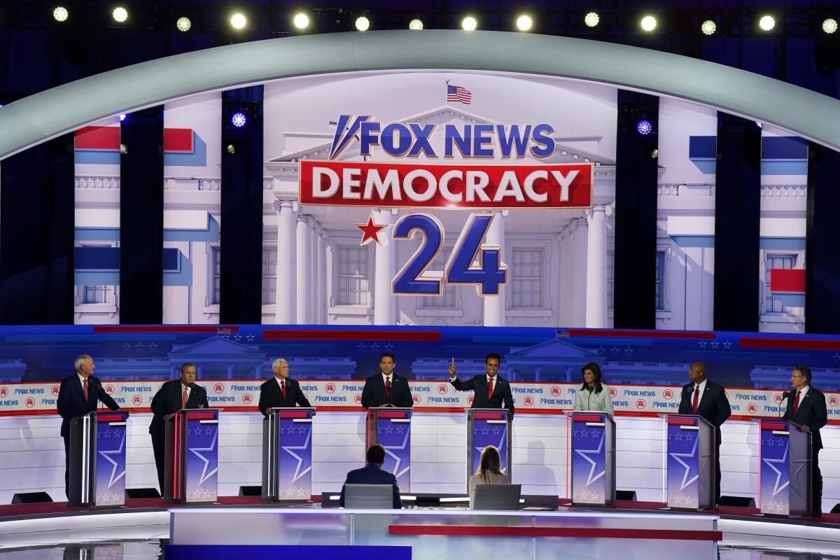 GOP candidates stand behind podiums on stage at a debate