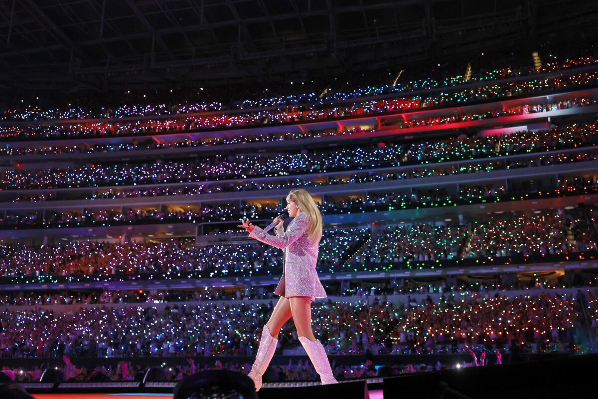 A pop star performs for a huge arena.