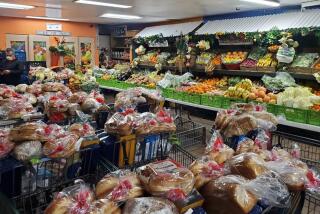 Shopping carts, shelves and tables filled with produce and groceries at World Harvest.