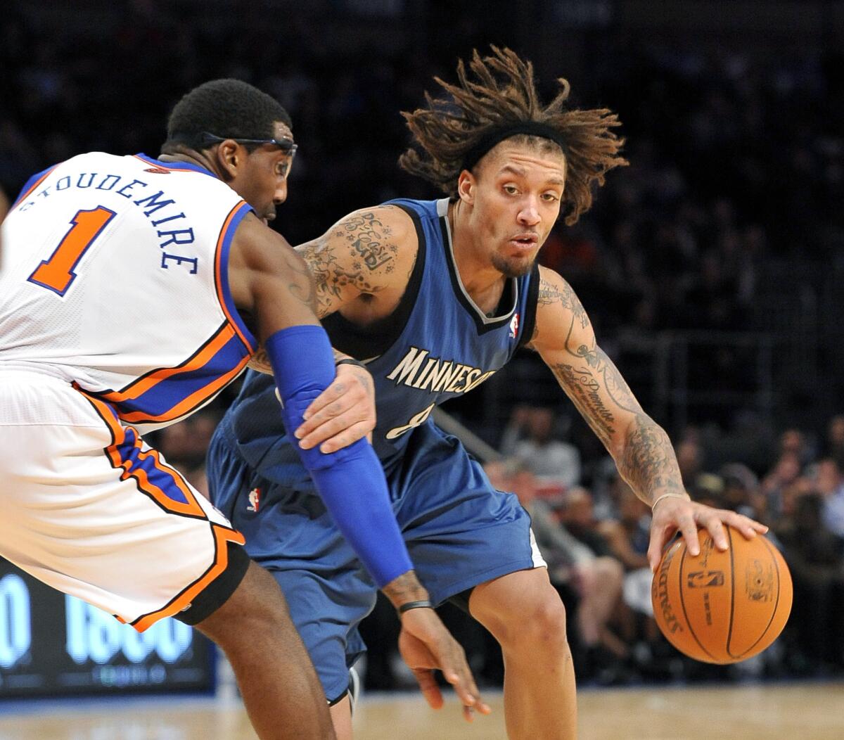 Minnesota Timberwolves forward Michael Beasley (8) tries to drive the ball around New York Knicks forward Amare Stoudemire (1) during the second half of an NBA basketball game Monday, Dec. 6, 2010, in New York. The Knicks defeated the Timberwolves 121-114.