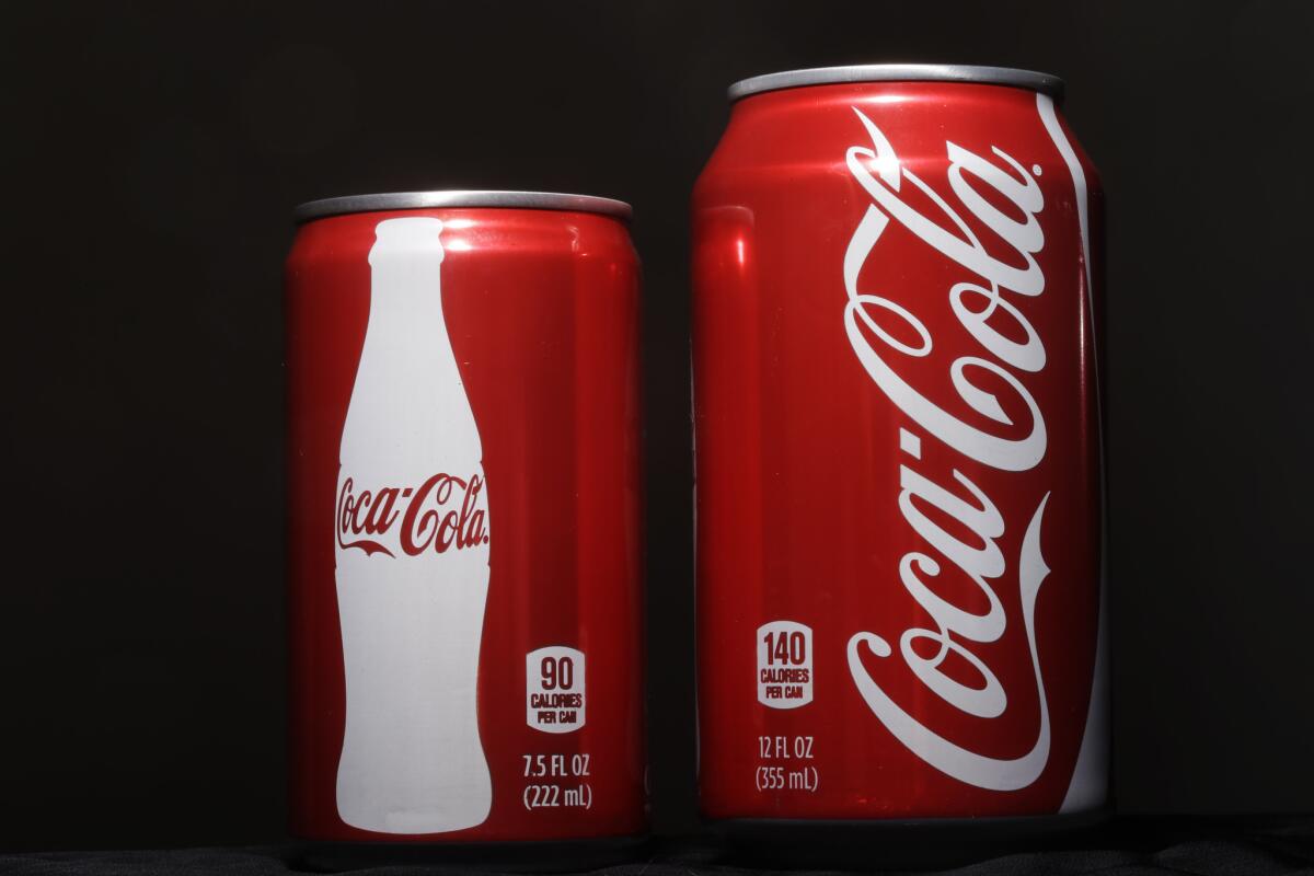 A 7.5-ounce can of Coca-Cola is posed next to a 12-ounce can for comparison on Jan. 12, 2015, in Philadelphia.