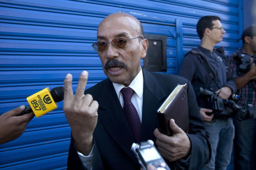 Telesforo Guerra, the lawyer for software company founder John McAfee, speaks Friday to journalists outside the detention center in Guatemala City where McAfee is being held.