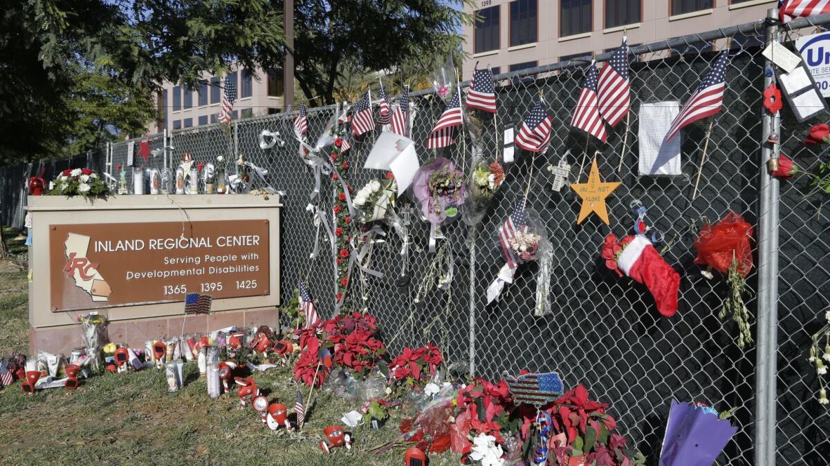 Flowers and American flags placed at the Inland Regional Center in San Bernardino honor victims of the terrorist attack on Dec. 2, 2015, that killed 14 people and wounded 22.