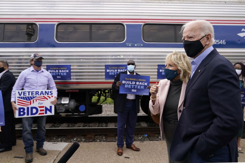 Democratic presidential candidate former Vice President Joe Biden and Jill Biden, speak with supporters before boarding a train at Amtrak's Cleveland Lakefront train station, Wednesday, Sept. 30, 2020, in Cleveland. Biden is on a train tour through Ohio and Pennsylvania today. (AP Photo/Andrew Harnik)