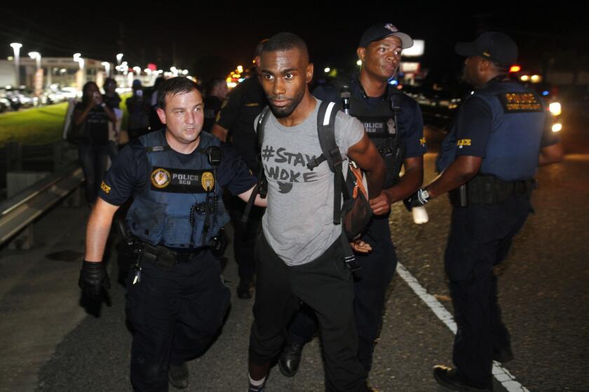 Police arrest activist DeRay McKesson during a protest along Airline Highway, a major road that passes in front of the Baton Rouge Police Department headquarters, on Saturday, July 9, 2016.