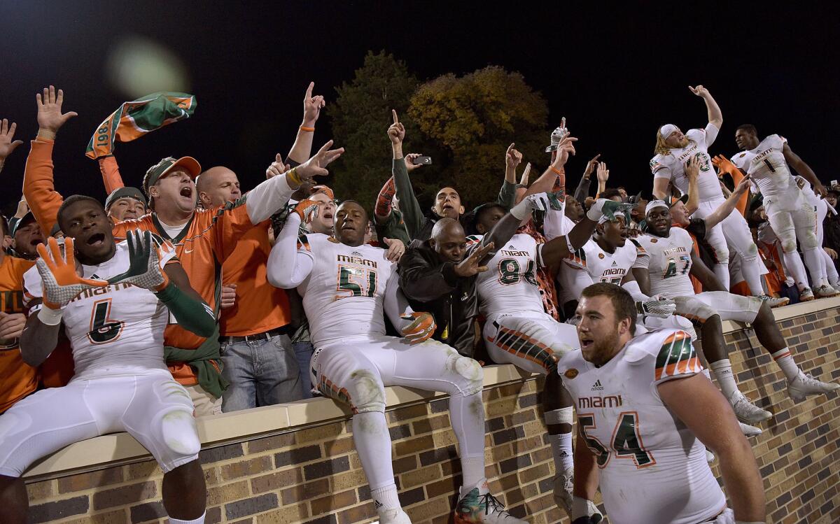 Miami Hurricanes players and fans celebrate after a win against the Duke Blue Devils at Wallace Wade Stadium on Oct. 31.
