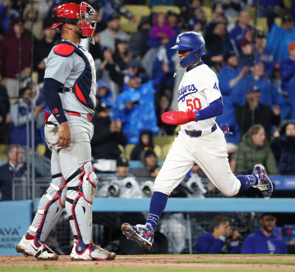 Dodgers baserunner Mookie Betts scores during the fifth inning against the Cardinals on Saturday.