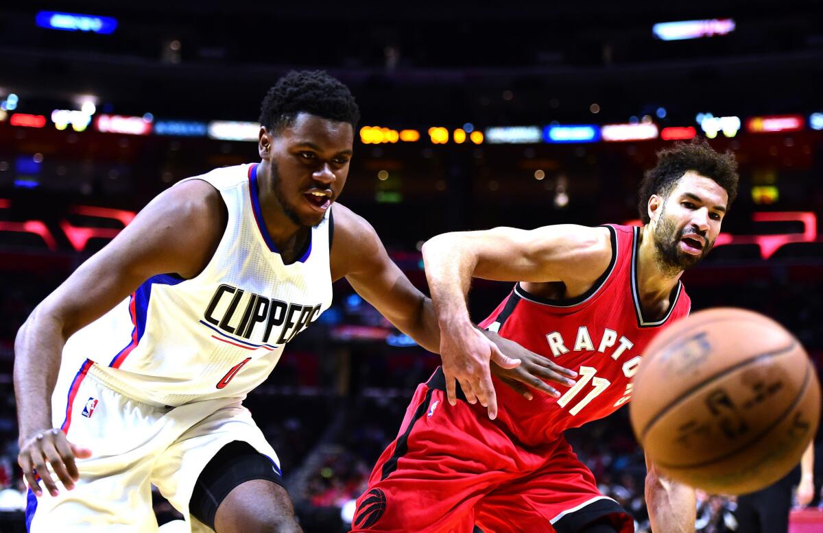 Clippers forward Diamond Stone and the Raptors' Drew Crawford chase after a loose ball during a preseason game Oct. 5.