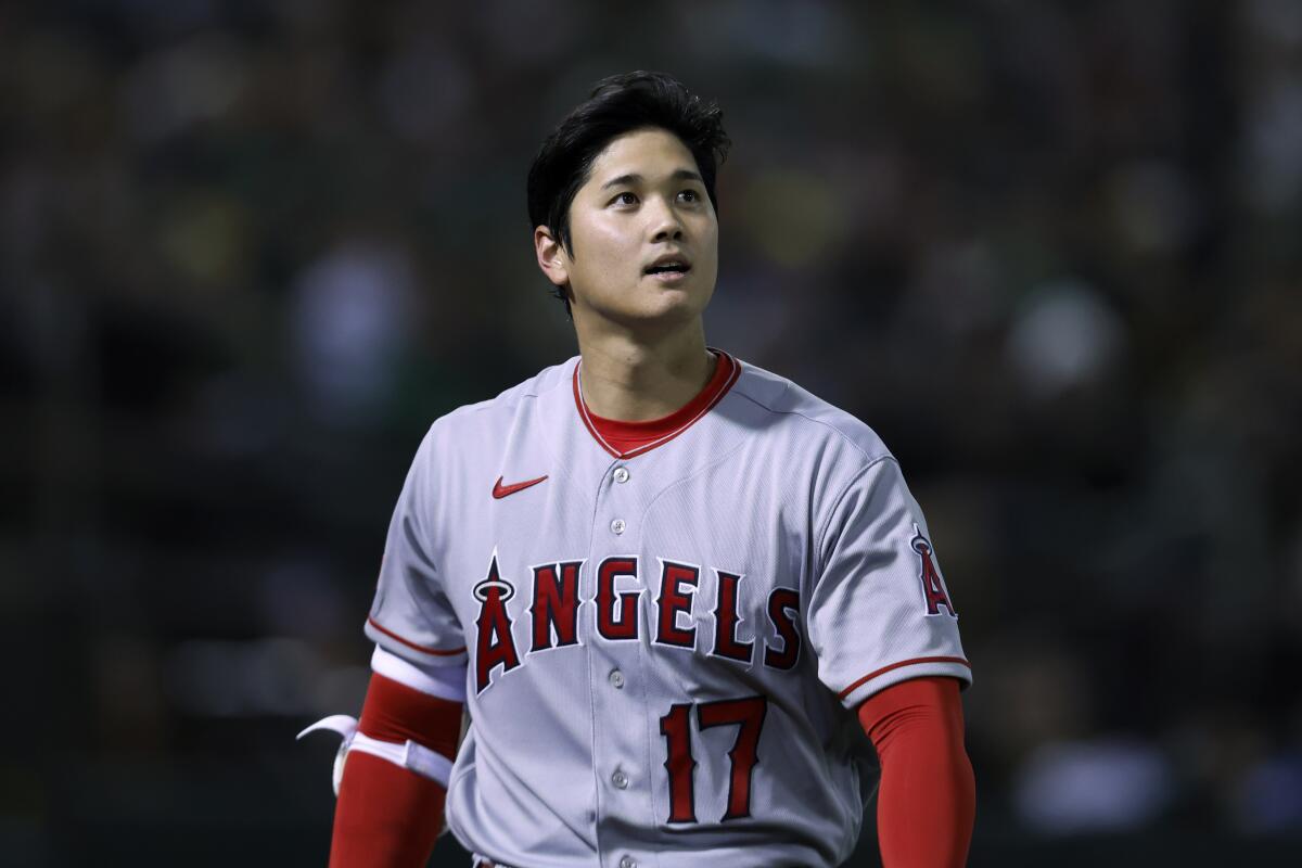 Shohei Ohtani walks back to the dugout after striking out against the Oakland Athletics in the sixth inning Thursday.