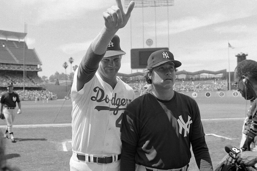 Los Angeles Dodger pitcher Jerry Reuss gives the big number one standing with New York Yankees Rich Gossage during warm-ups, July 8, 1980 in Los Angeles for the All-Star Game Tuesday. (AP Photo/Lennox McLendon)