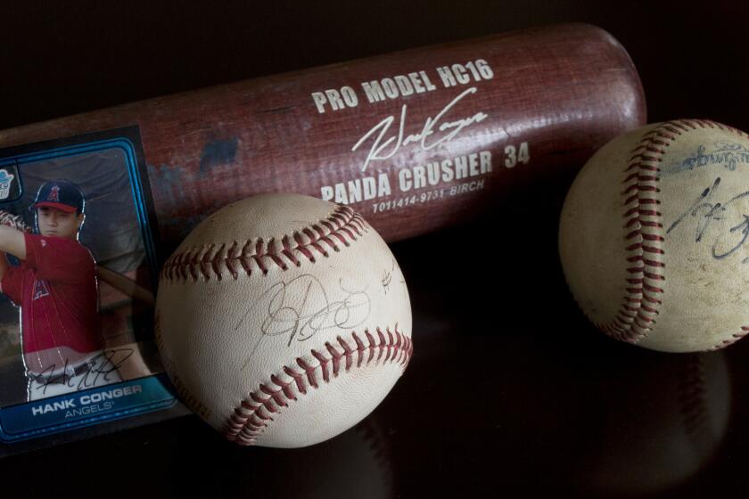 Anaheim Angels catcher Hank Conger's signature has evolved at least a couple times since his childhood playing days. The ball autographs from his early playing days differ from his current autograph, which is etched on the bat.
