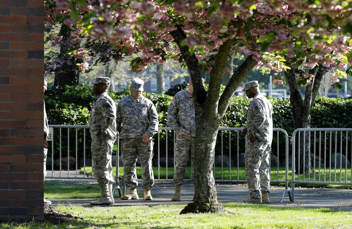 Soldiers stand guard outside a building at Joint Base Lewis-McChord in Washington state. A court-martial is underway that will help determine the sentence for Army Sgt. John Russell, who killed five fellow service members at a mental health clinic in Iraq.