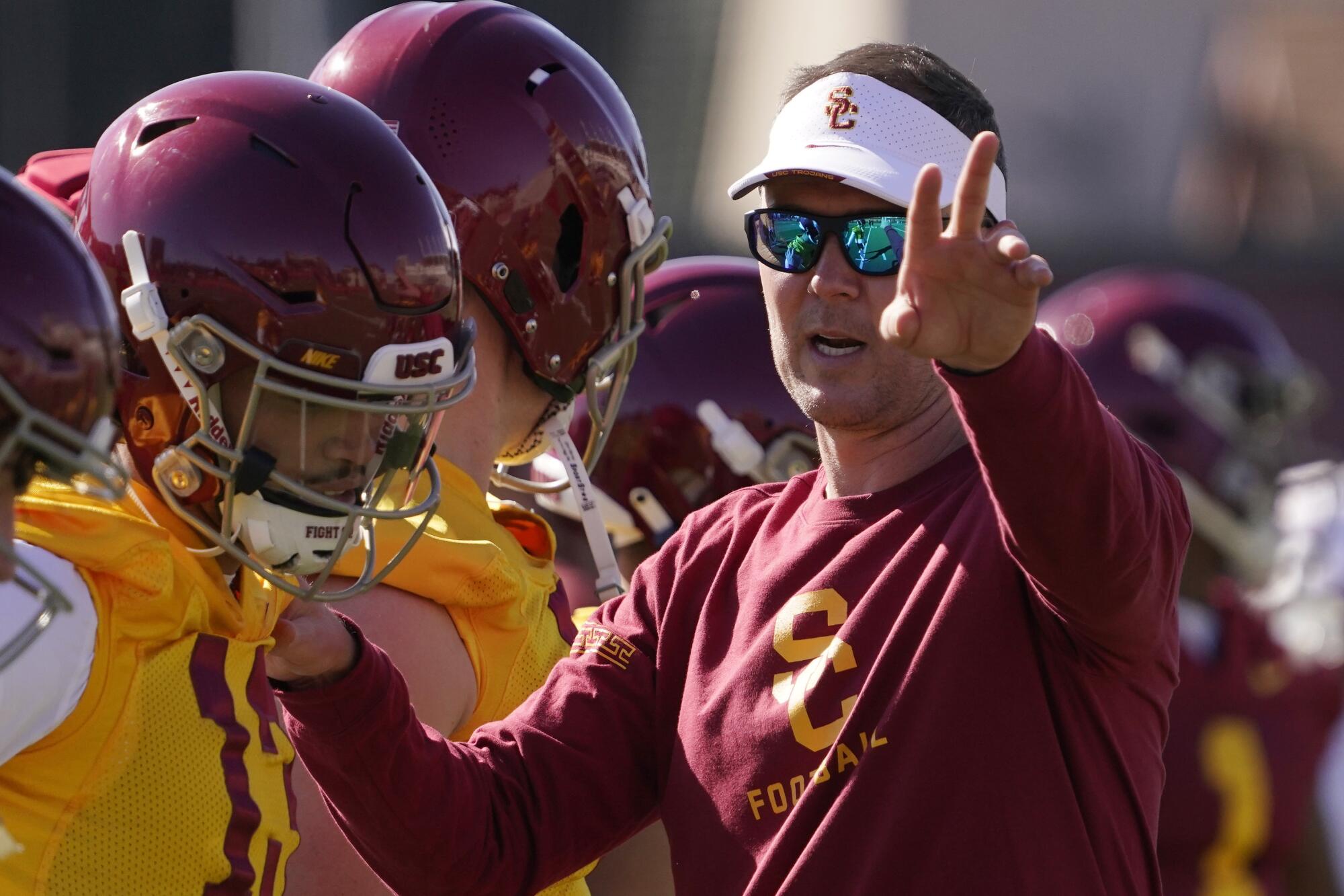 USC coach Lincoln Riley talks with quarterback Caleb Williams during a March practice.