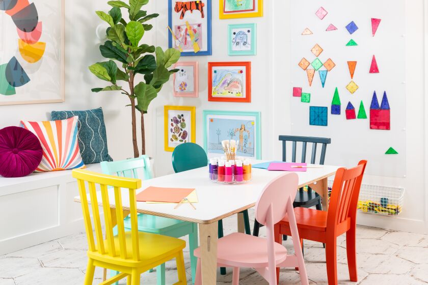 Splashes of color on the ceiling help define a play space in a converted dining room.