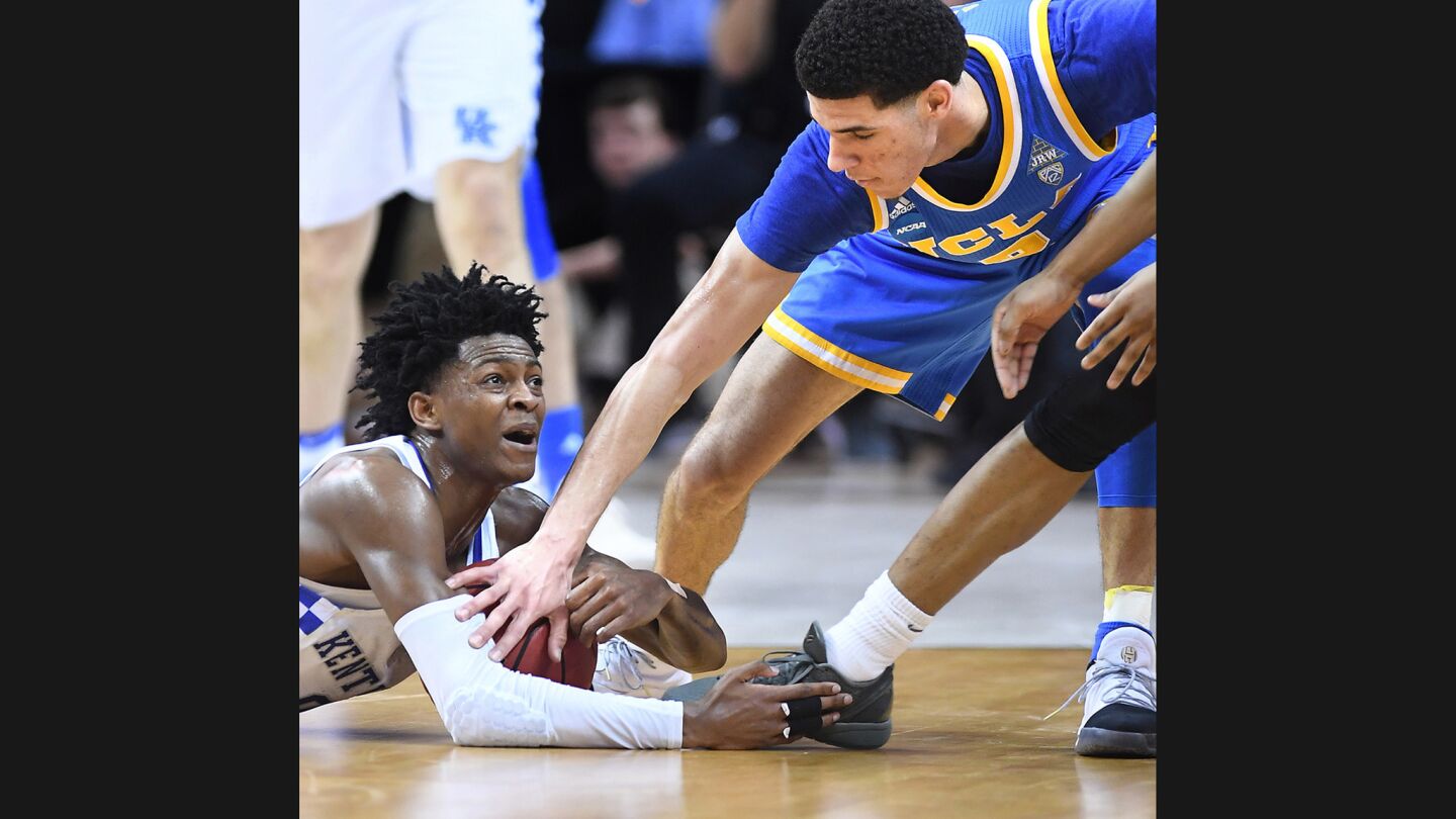 UCLA's Lonzo Ball tries to steal the ball away from Kentucky's De'Aaron Fox during the second half of a Sweet 16 game on March 24.