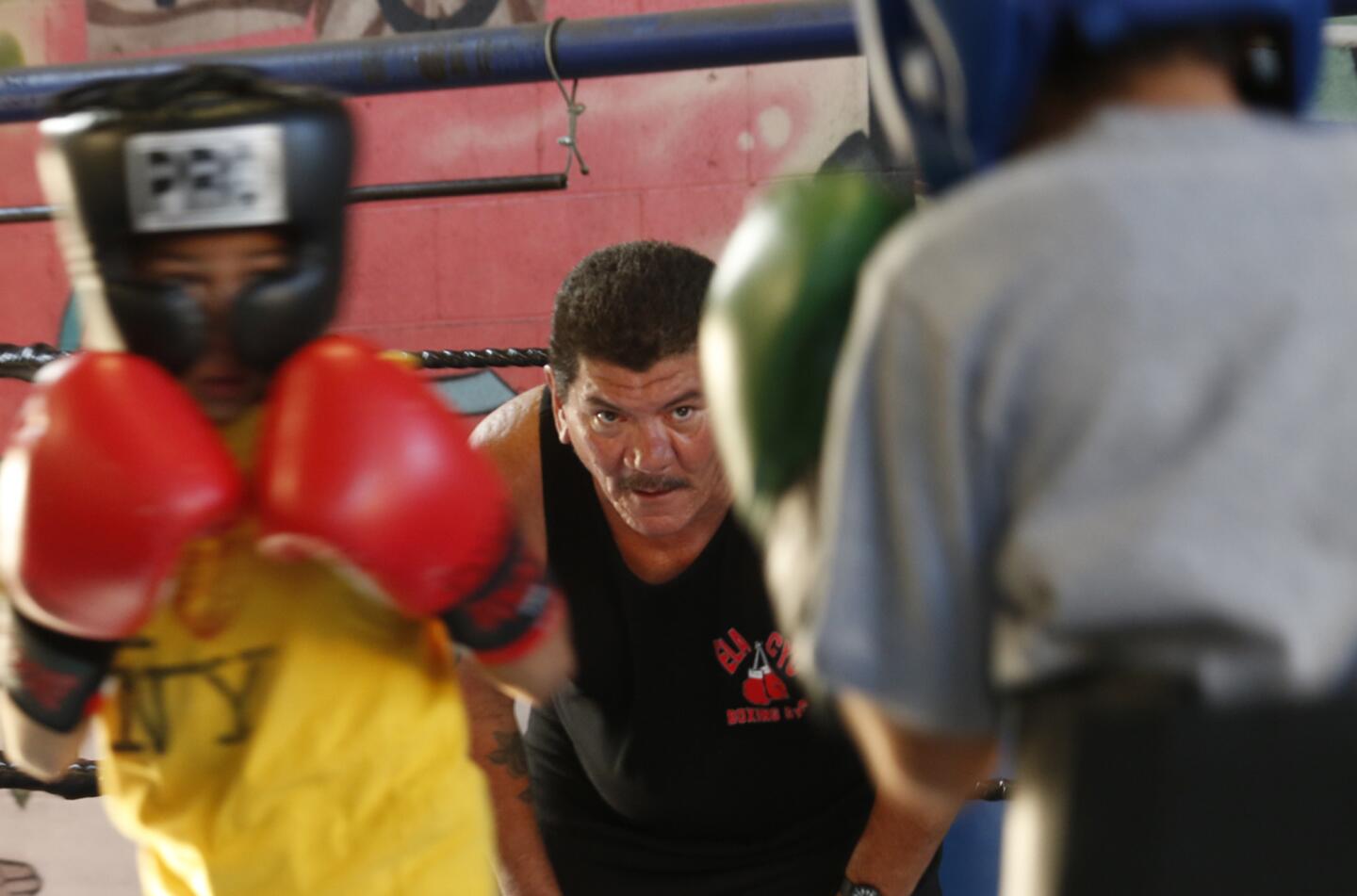 Boxing coach Paul Hernandez, 58, coaches and referees a sparring match between two young boxers at the East Los Angeles Community Youth Center in East Los Angeles on July 1. Hernandez has been fighting to keep the gym from closing due to the possible purchase of the property by a charter school.
