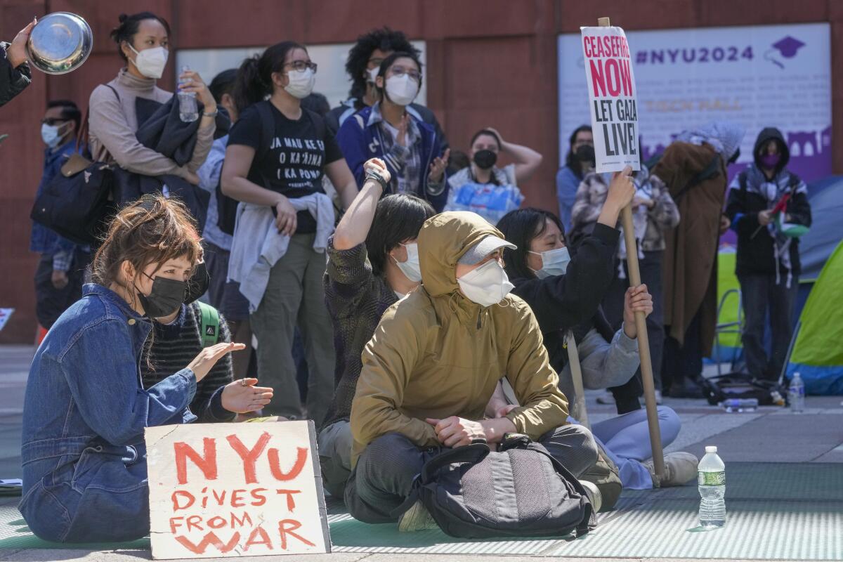 Pro-Palestinian activists rally outside an NYU building.