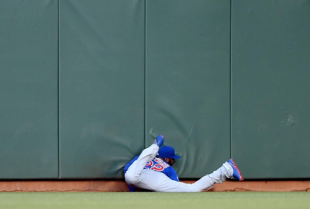 Cubs outfielder Jason Heyward slides into the wall while robbing Giants outfielder Denard Span of a hit during the first inning of a game on May 20 at AT&T Park.