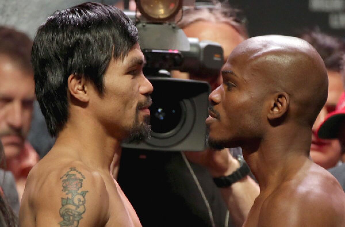 Manny Pacquiao, left, and Timothy Bradley stand toe to toe after their weigh-in on Friday.