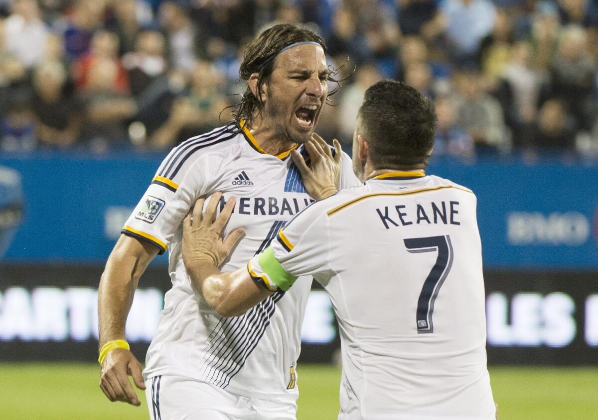 The Galaxy's Alan Gordon, left, celebrates with Robbie Keane after his goal against the Montreal Impact in the second half of a match Sept. 10.