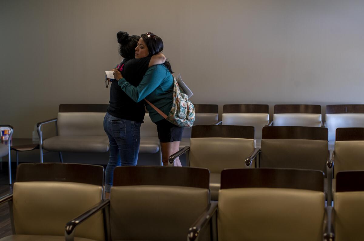 A staff member hugs a patient at a women's clinic