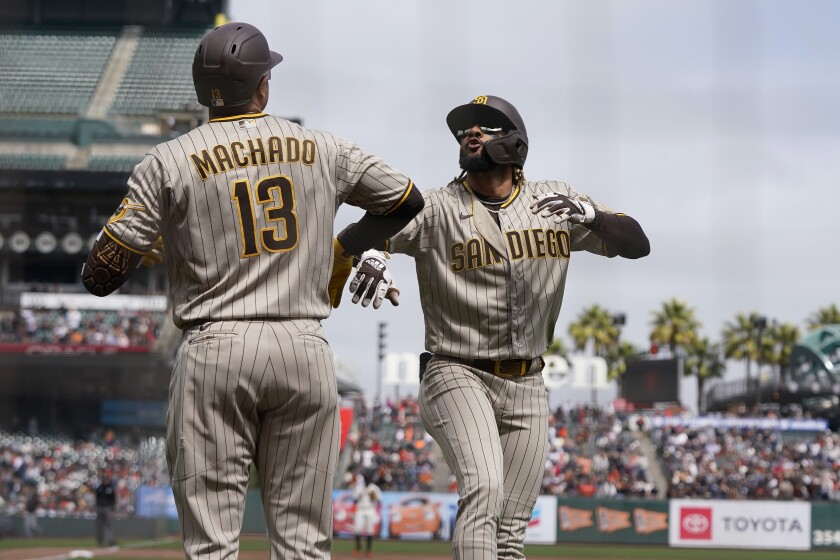San Diego Padres' Fernando Tatis Jr., right, celebrates with Manny Machado after hitting a home run.