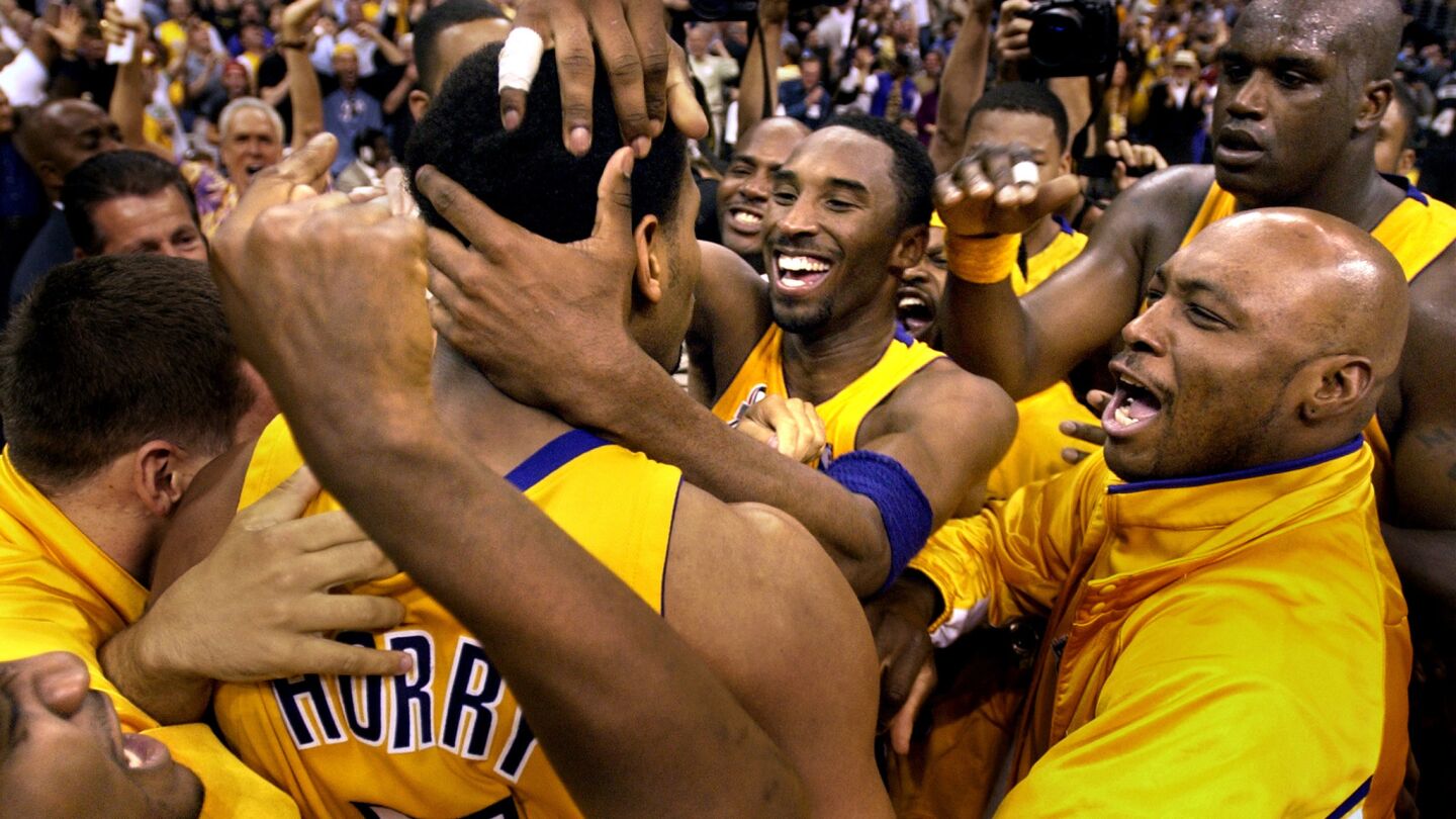 Lakers star Kobe Bryant, right center, congratulates teammate Robert Horry on his winning shot against the Sacramento Kings in Game 4 of the Western Conference finals at Staples Center on May 26, 2002.