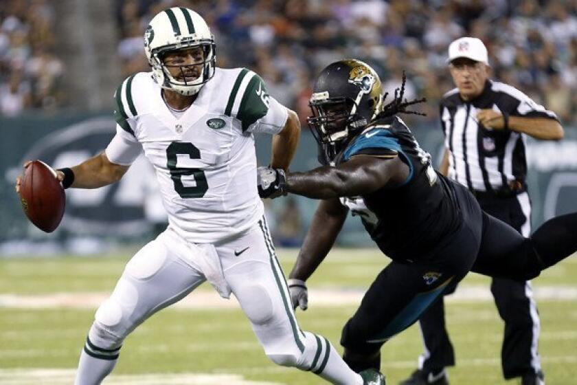 Jets quarterback Mark Sanchez (6) tries to evade the rush of Jaguars defensive tackle Sen'Derrick Marks in the first half Saturday night.