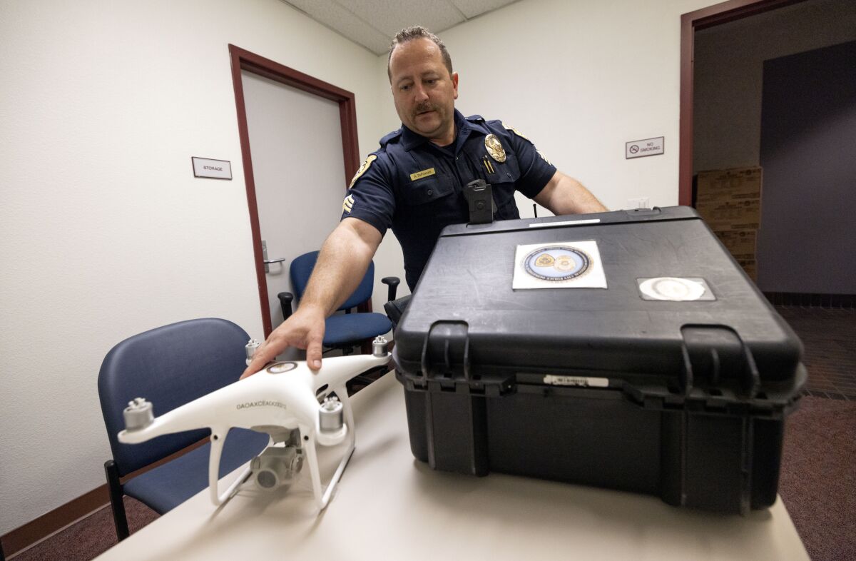 National City police Sgt. Aaron DePascale pulls one of the department's drones out of its case.