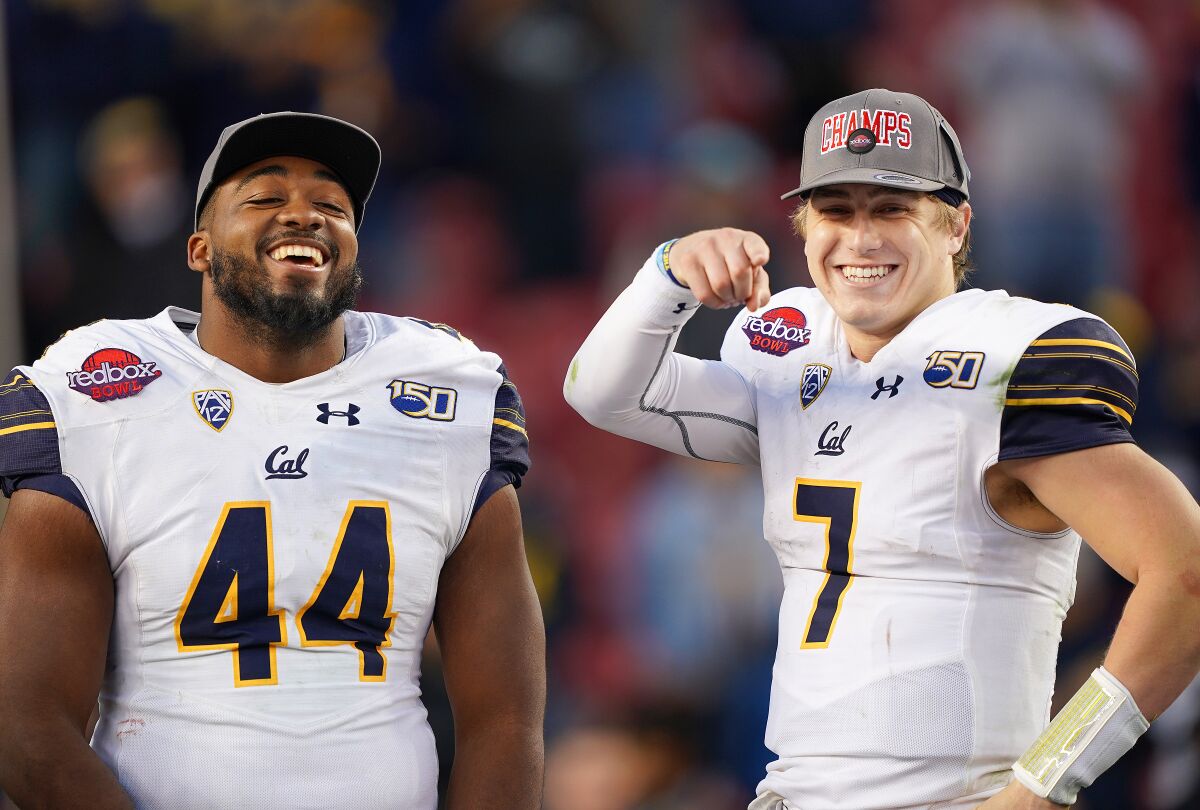 California's defensive player of the game Zeandae Johnson and offensive player of the game Chase Garbers celebrates after a victory over Illinois on Monday in the Redbox Bowl.