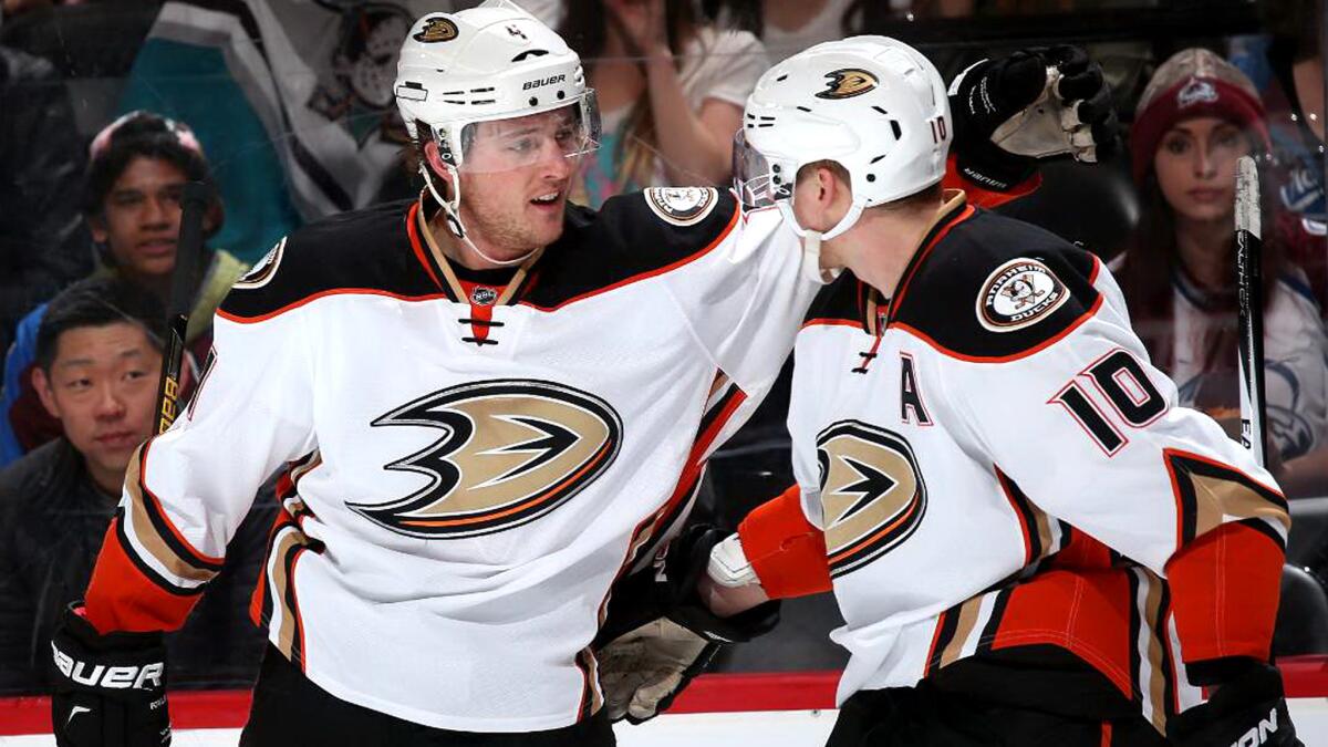 Ducks defenseman Cam Fowler celebrates with teammate Corey Perry (10) after scoring against the Avalanche in the first period Saturday.