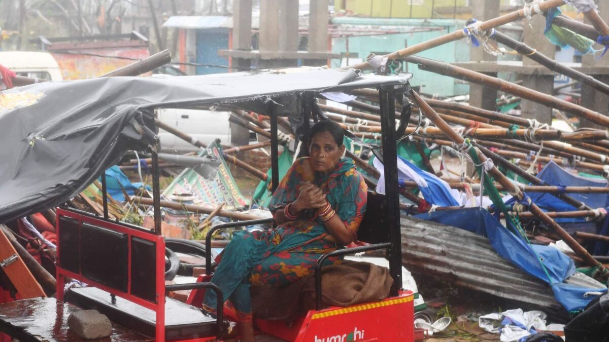 A woman sits in a taxi amid the rubble of structures blown down by Cyclone Fani in Puri in the eastern Indian state of Odisha on May 3, 2019.