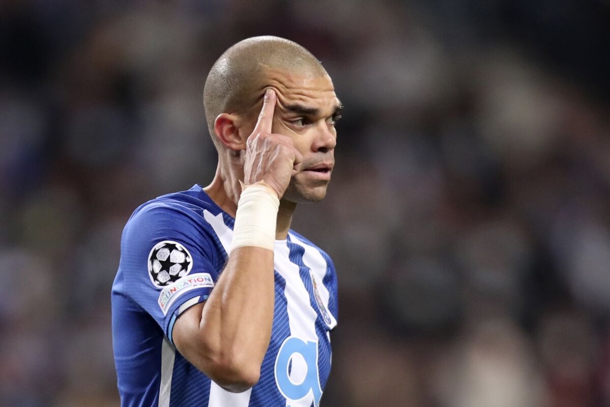 FILE - Porto's Pepe rubs his head during their Champions League Group B soccer match against Atletico Madrid at the Dragao stadium in Porto, Portugal, Tuesday, Dec. 7, 2021. Porto defender Pepe has been suspended for two matches after being accused of kicking an official from another team during a brawl in the Portuguese league last week. The veteran Portugal international was red carded for allegedly kicking a Sporting Lisbon club director during the altercation at the end of the 2-2 draw between the teams on Friday, Feb. 11, 2022. (AP Photo/Luis Vieira, file)