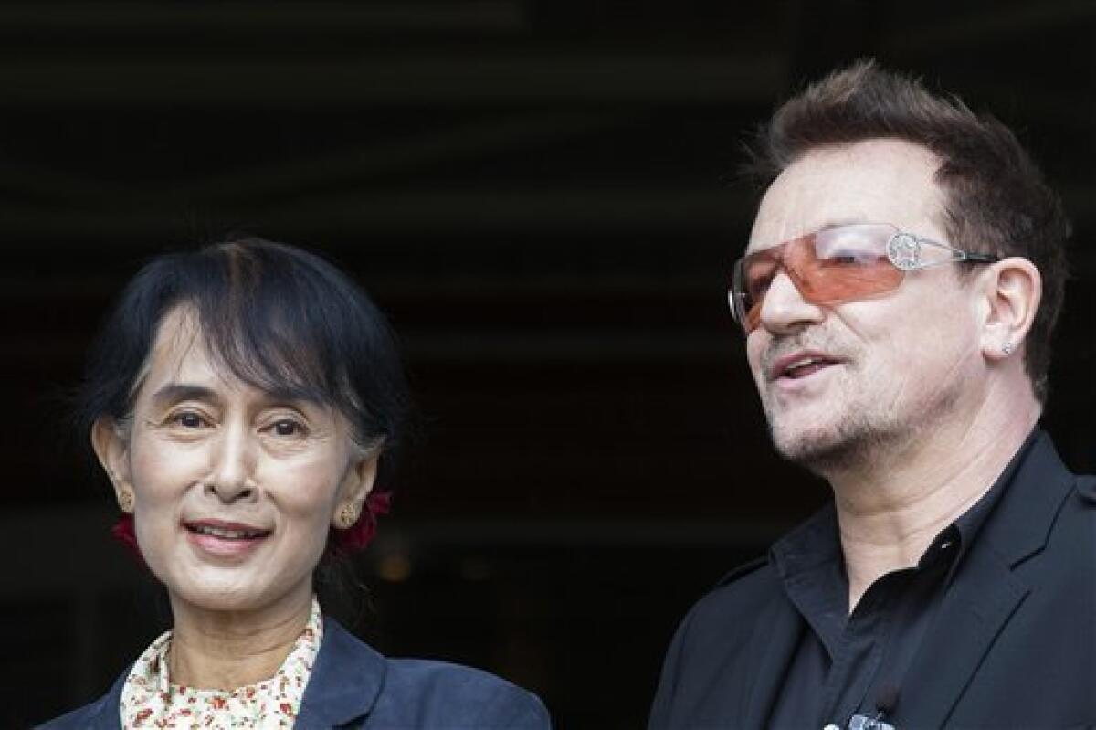 Irish singer and activist Bono and Myanmar's opposition leader Aung San Suu Kyi, left, pose for the media after attending a conference of the Oslo Forum at the Losby Gods resort, about 13 kilometers (8 miles) east of Oslo, Monday, June 18, 2012. The Oslo Forum is an international network of armed conflict mediation practitioners. (AP Photo/Markus Schreiber)
