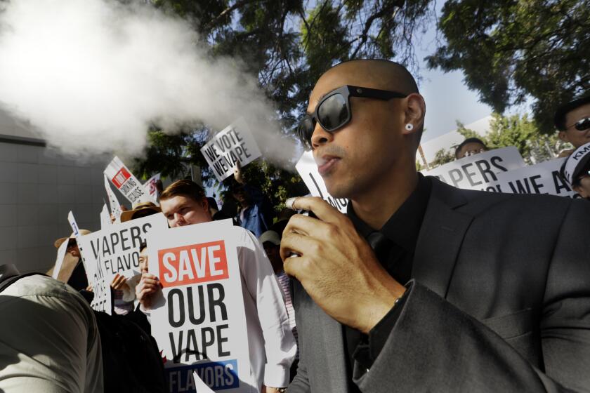 LOS ANGELES, CALIFORNIA--SEPT. 24-2019--Jay Joaquin, age 27, of West Covina, is in support of vaping. He rallied in front of the LA Civic Center on Sept. 24, 2019. Both pro-and anti-vaping supporters showed up at the Los Angeles County Board of Supervisors, set to take the first of two votes on an ordinance Tuesday restricting sales in unincorporated areas of LA. (Carolyn Cole/Los Angeles Times)