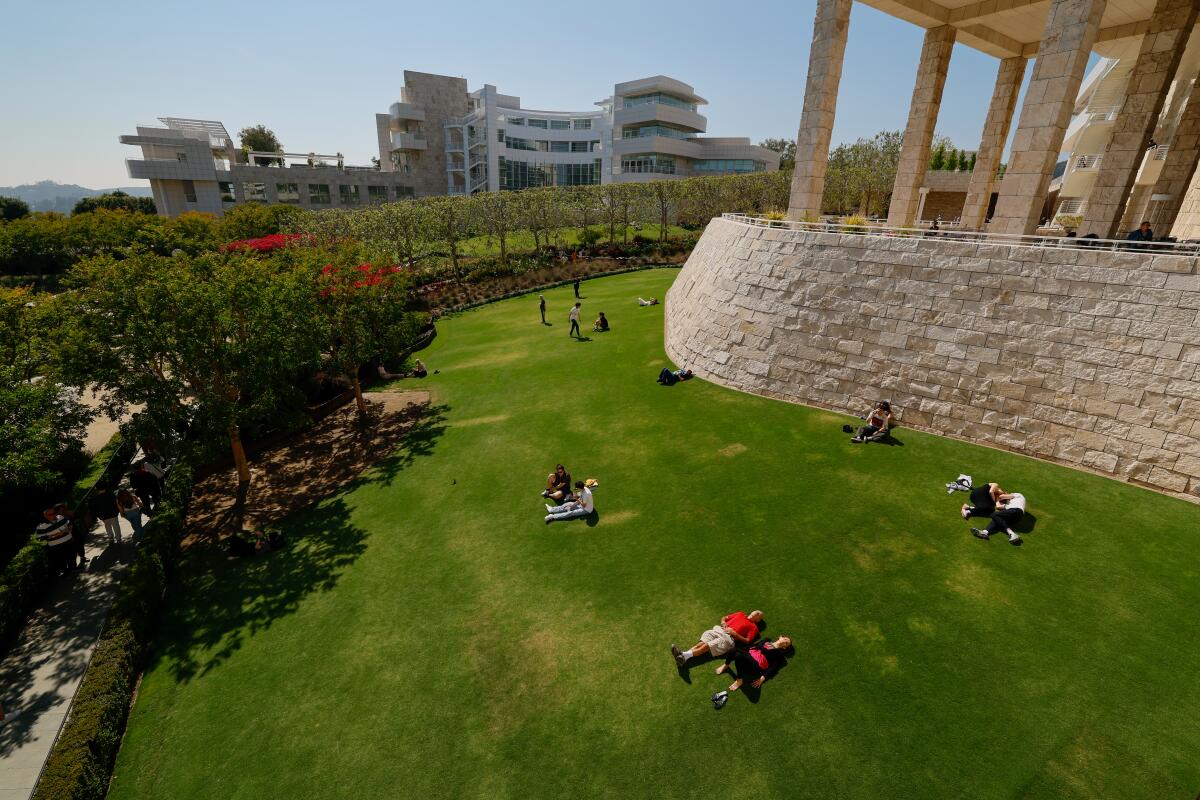 Sunbathers soak up the rays on a lawn at the Getty Center.