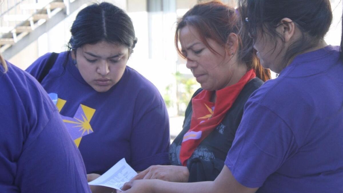 Yamilex Rustrian, left, of North Hollywood and Leticia Soto of Los Angeles check Las Vegas addresses to visit as they encourage residents to support Hillary Clinton.