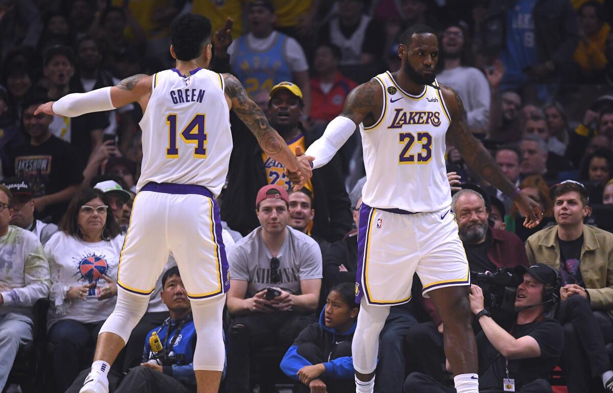 Lakers All-Star forward LeBron James (23) celebrates with teammate Danny Green after scoring against the Clippers during a victory on March 8, 2020.