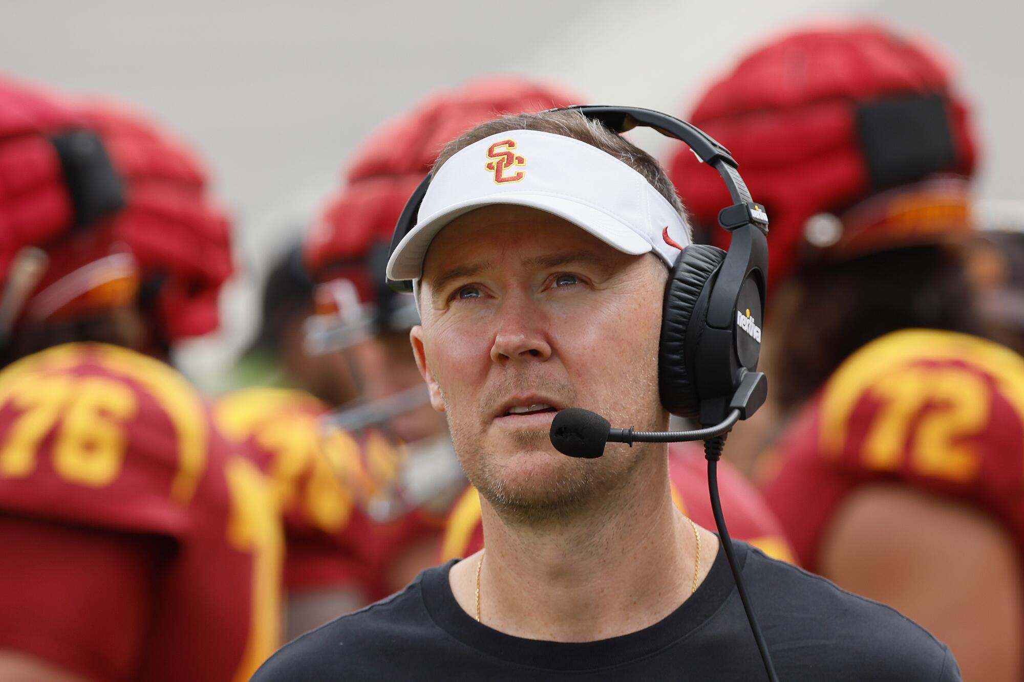 USC coach Lincoln Riley looks up and across the field during the Trojans' spring game at the Coliseum.