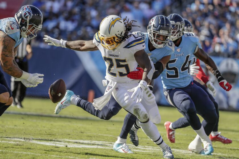 NASHVILLE, TN, SUNDAY, OCTOBER 20, 2019 - Los Angeles Chargers running back Melvin Gordon (25) looks to recover his own fumble during a first quarter run against the Titans at Nissan Stadium. (Robert Gauthier/Los Angeles Times)