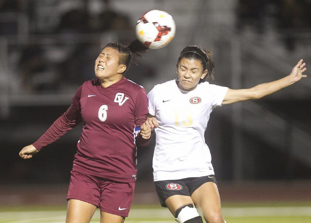 Ocean View's Daisy Moran, left, takes the ball off her head as she battles against a Segerstrom defender.