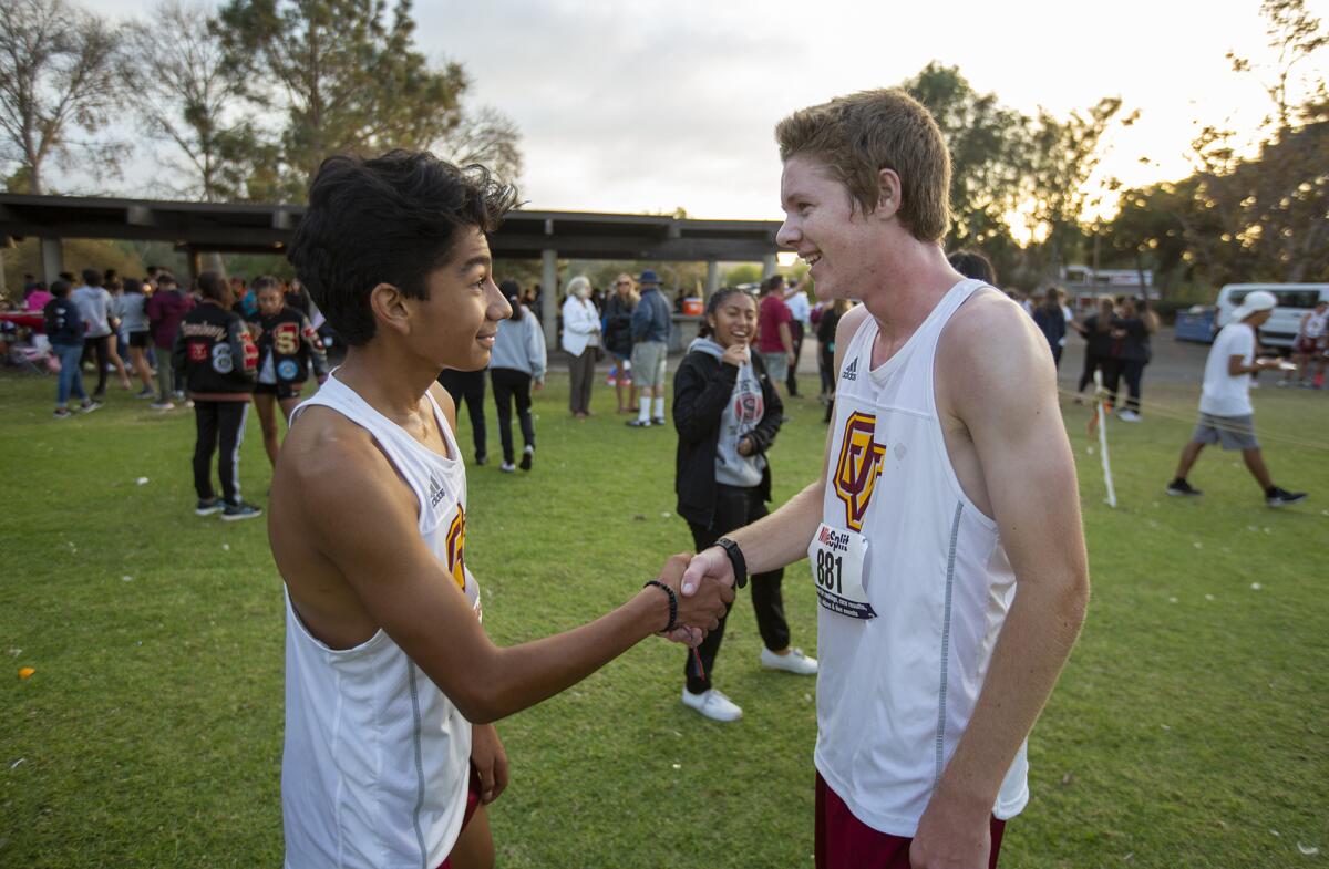 Ocean View's Diego Gonzalez, left, shakes hands with Parker Walpole following the Golden West League finals at Central Park in Huntington Beach on Wednesday.